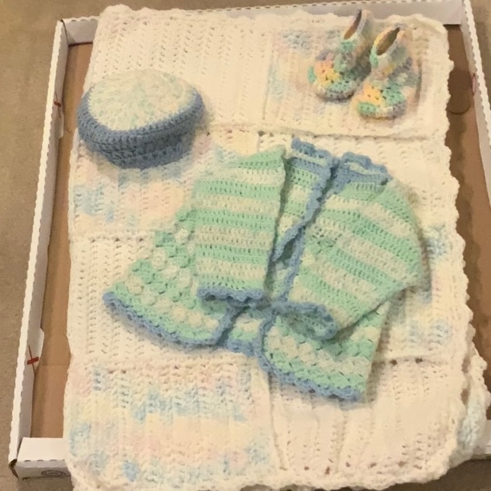 A beautiful hand crocheted set of four pieces for a baby.